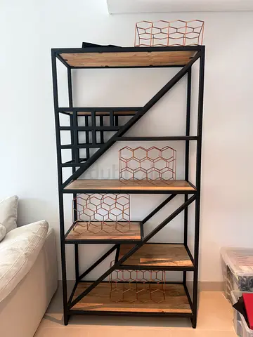 Industrial-style open shelving unit with wooden shelves and metal frame