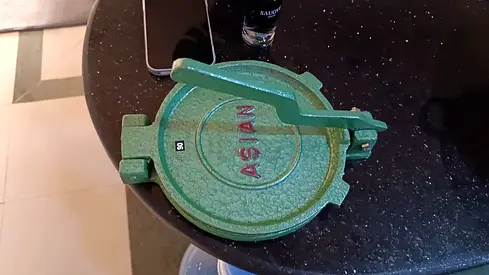 Green manual chapati and puri press machine featuring the "ASIAN" brand imprint.