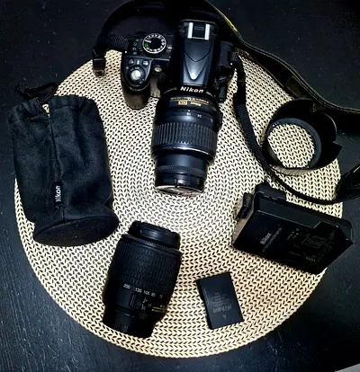 Nikon DSLR D3100, 18-55 mm lens, 55-200 mm lens, lens hood, UV filter, charger, lens pouch, bag