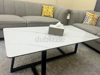Two 2-seater sofas and one 3-seater sofa, plus a table, located in Sharjah. In good conndition, used