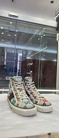 Pair of women's high-top designer sneakers, size unknown, gently used