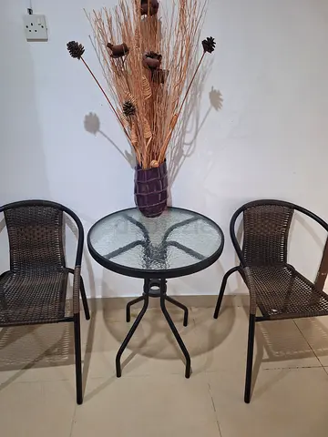 Outdoor bistro set – glass top table with two rattan chairs