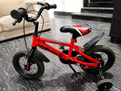 Red kids' 12-inch bicycle with training wheels - good condition