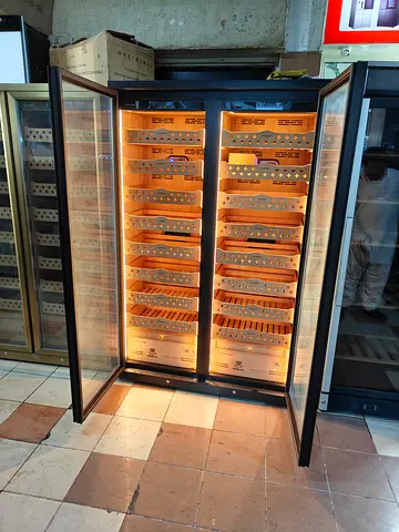 Reaching Premium Double-Door Humidor Cabinet with spacious wooden cigar storage shelves,