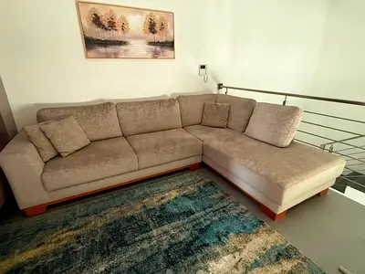 Light beige L-shaped sectional sofa in good condition