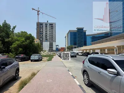 Residential building plot for sale on a paved road, prime location opposite the Ajman Free Zone, Port, and Customs. Freehold corner plot on 3 streets.