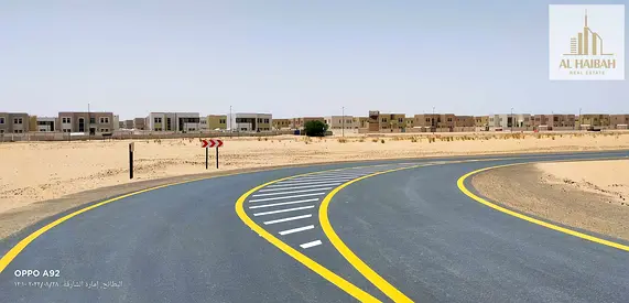 Two adjacent residential plots for sale in Sharjah, Rawdat Al Qurt area, prime location.