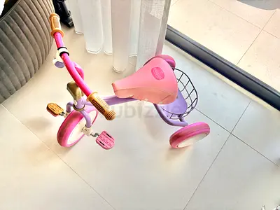 Pink and purple three-wheel toddler tricycle with basket