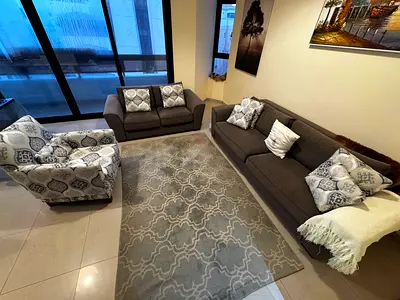3-piece grey sofa set with patterned accent chair and matching rug