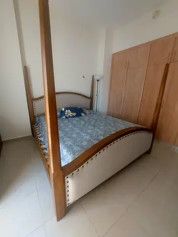 Four-poster wooden super king bed