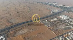 An industrial land in the Al Bataih area with a prime location, entrance from Al Dhaid Road and Khor