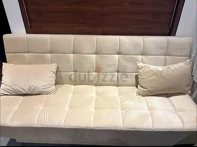 Beige tufted 3-seater sofa bed / futon in good condition