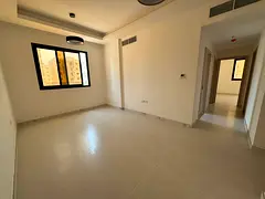 Available for annual rent, a premium 2-bedroom apartment with a spacious living room in Al Jurf 3, A