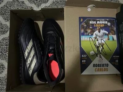 Adidas football boots signed by Roberto Carlos with collectible card