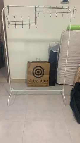 Practical white iron clothes stand, with additional chrome hangers for walls and doors.