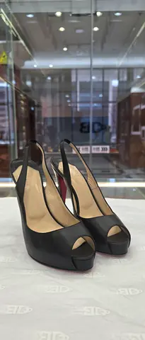 Black leather peep-toe slingback heels, size not specified