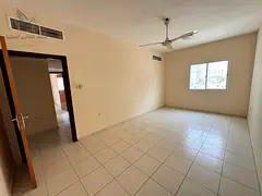 Two bedrooms and a large living room with a balcony and central air conditioning.
