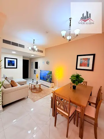 Sharjah, Al Taawun area, two-bedroom apartment with living room, kitchen, two bathrooms, shower, and balcony.