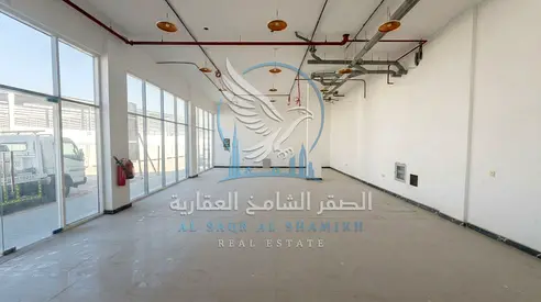 Factory for rent in Al Sajaa, 9,000 sq. ft., with showroom, offices, 3,500 sq. ft. warehouse with weighing scale, and 148 kW electricity, expandable.