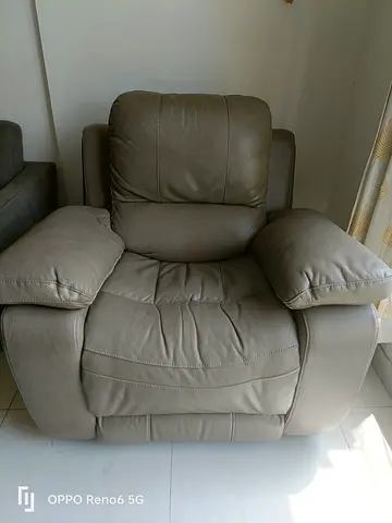 Single leather recliner armchair — comfortable grey/brown and study table and study shelves.