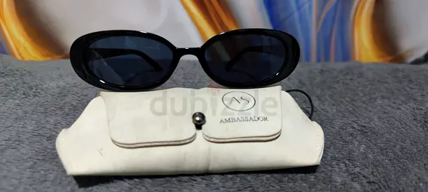 Ambassador black oval sunglasses with soft white case