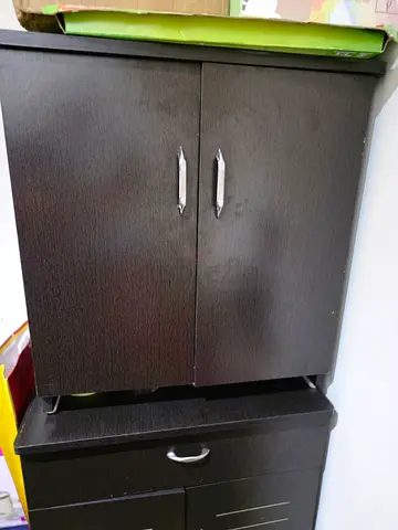 Dark wood cabinet with drawers — compact storage unit