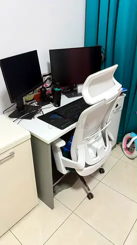 White ergonomic office chair with desk having 1 drawer unit and 1 cabinet - light use