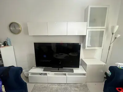 White modular TV entertainment unit with wall cabinets and storage