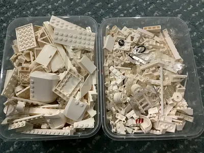 2 lego boxes with sorted white bricks