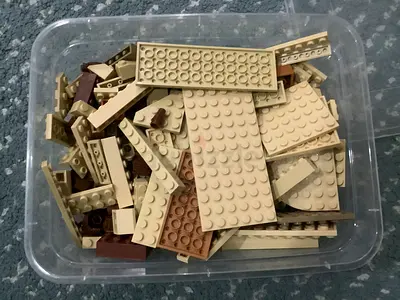 1 big lego box with beige and brown bricks