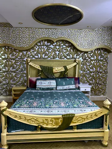 Elegant carved wooden king-size bed with mattress