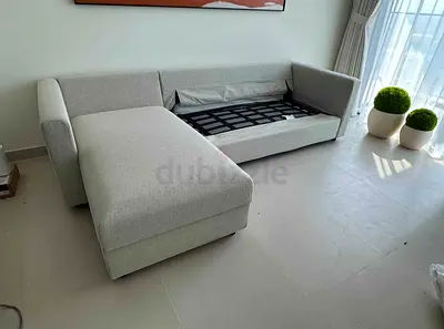 Light grey L-shaped fabric sofa with chaise - good condition