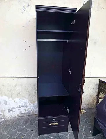 Tall single-door wardrobe with drawer - dark wood finish