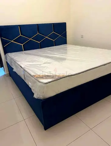 Blue upholstered king-size bed with storage and new mattress