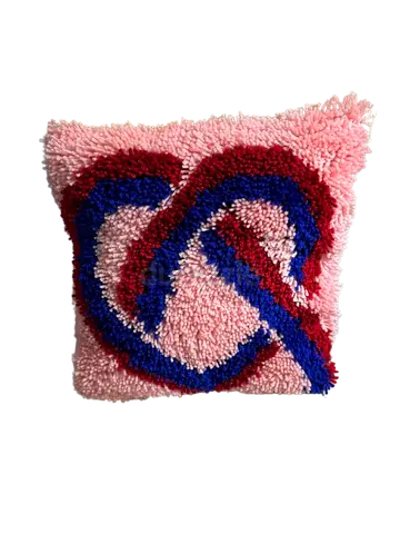 Handmade pink crochet decorative cushion with knot pattern