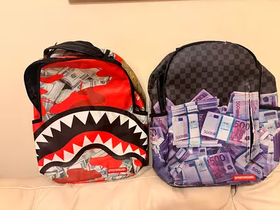Pair of Sprayground Graphic Backpacks with Money Print (Red & Grey)