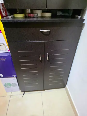Dark wood tall storage cabinet with double doors — good condition