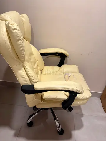 Cream leather swivel office chair with high back and armrests