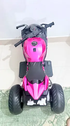 Pink electric ride-on motorcycle for kids - working condition