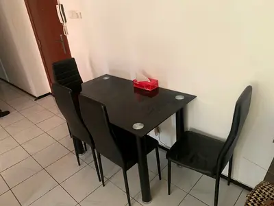 Black dining table with 4 matching chairs - compact set, one chair has a leg bent (can be fixed)