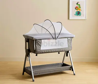 Portable baby bassinet with canopy and storage shelf - gently used- with bed