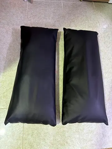 Pair of long black bolster cushions / bench pillows - good condition