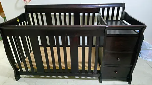 Giggles Dark wood convertible baby crib with attached dresser - in very good condition