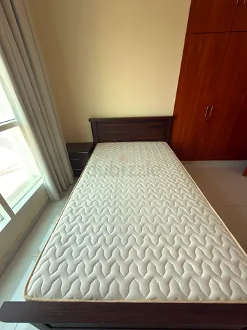 Bed with mattress and side unit