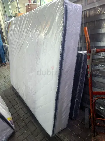 Brand new queen-size mattress wrapped in plastic - firm support
