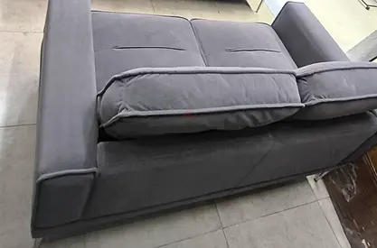 Two-seater grey fabric sofa in good condition