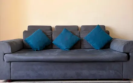 Gray 3-seater Sofa Bed with Blue Cushions - Good Condition