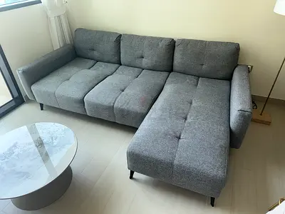 Light grey L-shaped sofa with adjustable backrests