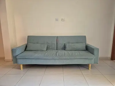 Light tea l3-seater sofa bed with wooden legs - good condition