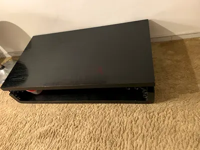 Low black wooden coffee table with storage shelf